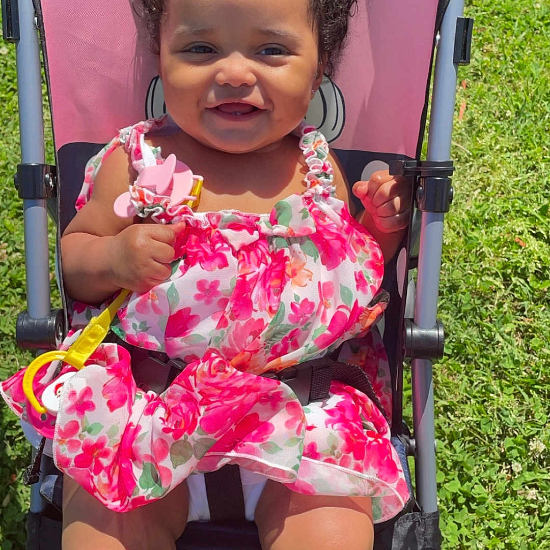Samaira is registered to the contest to win money with this photo: baby, backyard, clothing, dress, face, furniture, grass, happy, head, nature, outdoors, park, person, photography, plant, portrait, shorts, stroller, summer, yard