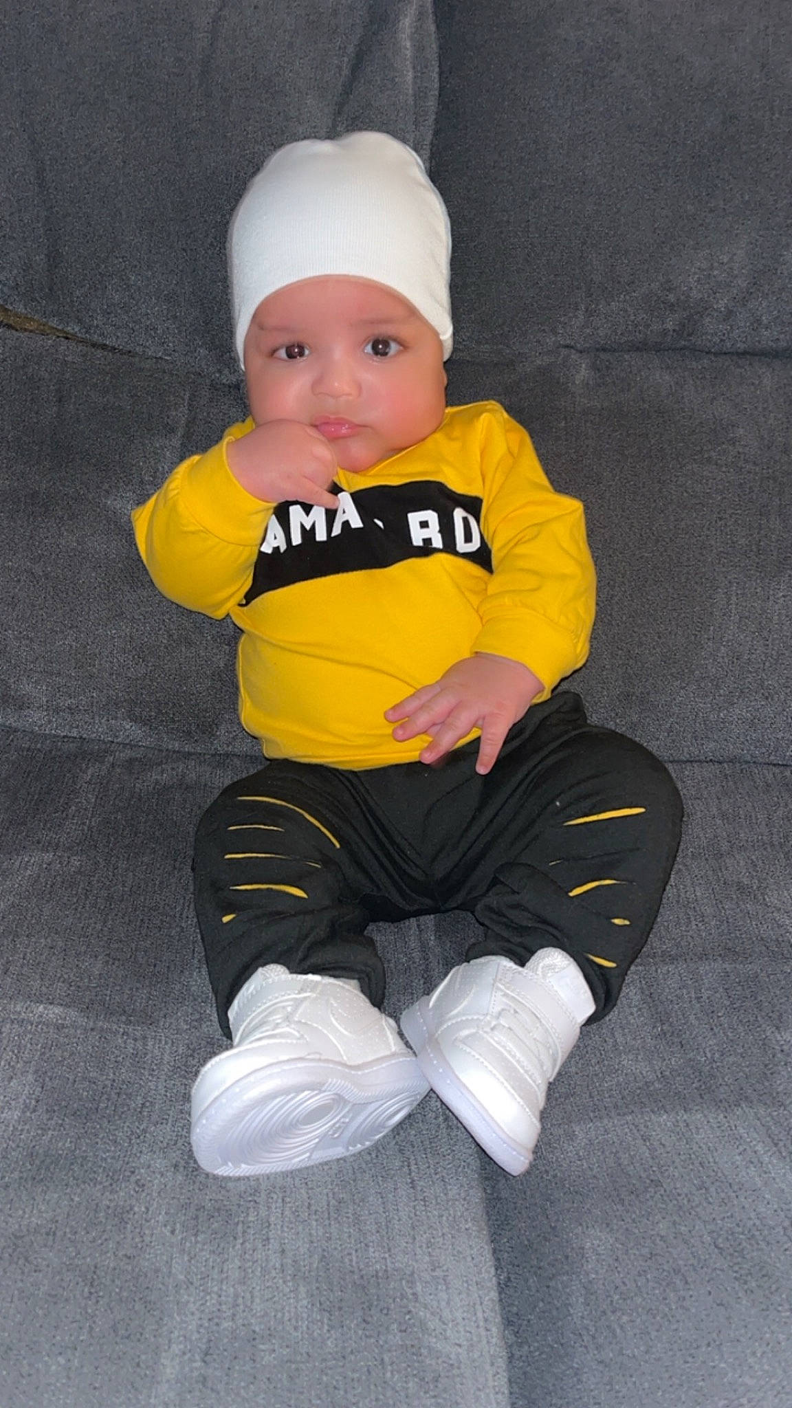 Arthur joined the competition — help win amazing prizes! arm, baby, baby_toddler_clothing, cap, carmine, cheek, child, comfort, costume_hat, hat, head, headwear, human_body, knee, lap, leg, person, sitting, sleeve, sock