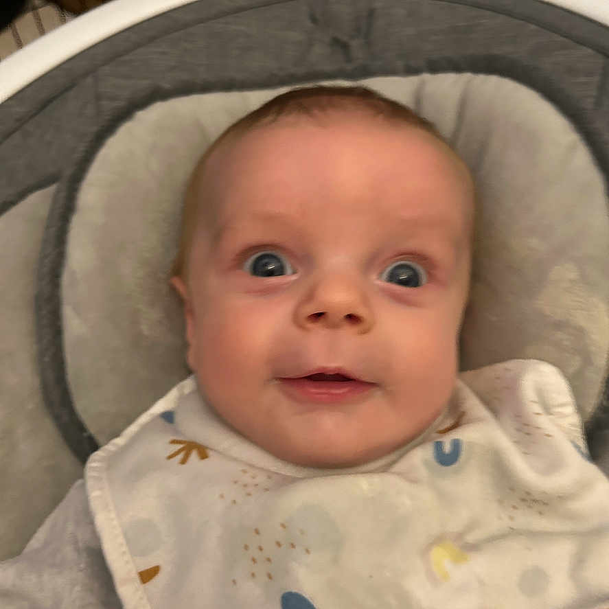 Oliver joined the competition — help win amazing prizes! baby, bib, child, clothing, cushion, cute, expression, eyes, face, happy, head, indoor, infant, mouth, nose, person, portrait, seat, skin, young