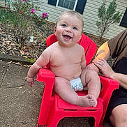 Kayson joined the competition — help win amazing prizes! baby, child, diaper, red_chair, smile, happy, outdoor, person, arm, garden, plant, window, house, daylight, skin, cute, sitting, holding, adult, nature