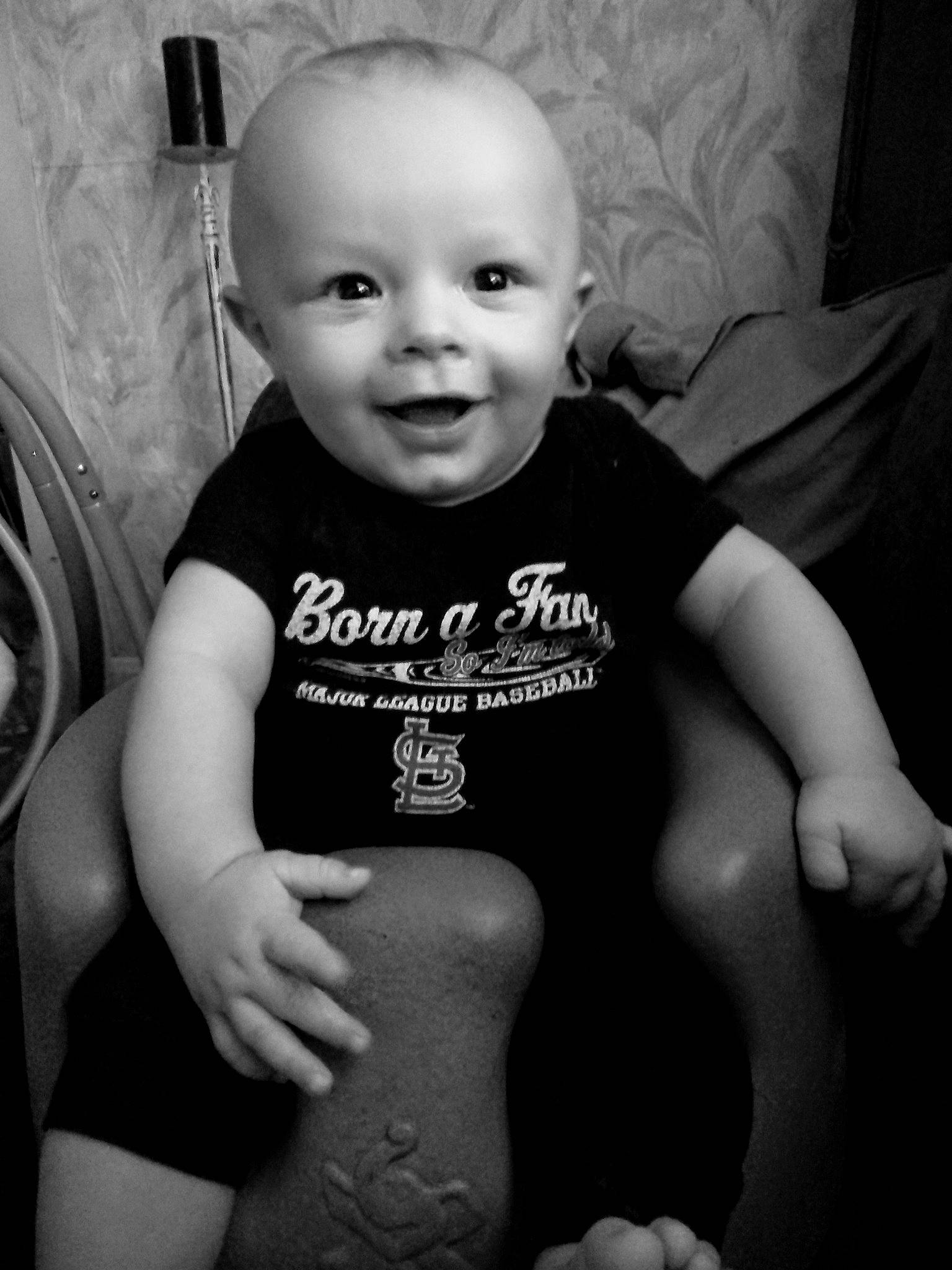 Leo is registered to the contest to win money with this photo: arm, black, black_and_white, cheek, child, emotion, eye, facial_expression, girl, hand, human, infant, monochrome, monochrome_photography, muscle, person, photography, skin, smile, white