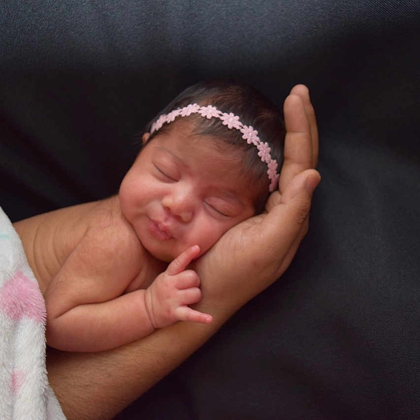 Krisha is registered to the contest to win money with this photo: arm, baby, birth, cheek, child, face, finger, gesture, hair_accessory, hand, head, headband, headgear, person, photograph, photography, pink, skin, sleep, thumb