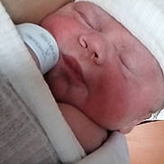 Lucenzo participe au concours pour gagner de l'argent avec cette photo : baby, blanket, closeup, cozy, cute, face, hat, human, indoors, infant, newborn, peaceful, person, portrait, resting, skin, sleeping, soft, wrapped, young