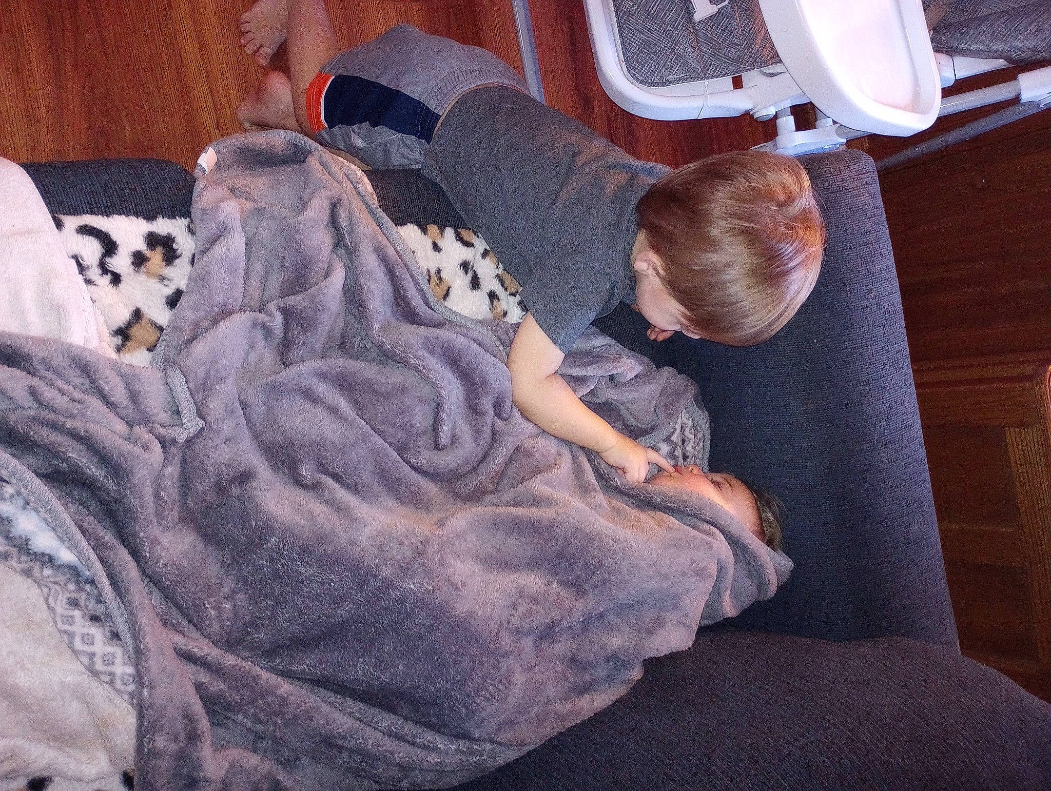 Jj is registered to the contest to win money with this photo: car_seat, child, comfort, couch, flooring, fun, human_leg, knee, lap, leg, leisure, living_room, luxury_vehicle, nap, passenger, person, purple, room, sitting, thigh