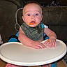 baby, barefoot, bib, blue_eyes, child, expression, face, feeding_time, feet, food_mess, hands, high_chair, indoor, infant, living_room, messy, person, sofa, surprised, wooden_floor