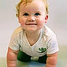 baby, child, crawling, blue_eyes, curly_hair, cactus_print, tshirt, smiling, cute, infant, hands, face, portrait, indoor, skin, expression, young, front_view, happy, plump