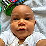 Wassym a rejoint le concours — aidez-le/la à gagner de superbes lots ! baby, infant, face, white_shirt, closeup, selfie, blanket, toy, colorful, cute, child, lying_down, smiling, skin, head, person, indoors, expression, chubby_cheeks, casual