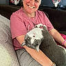 Boo is registered to the contest to win money with this photo: woman, smile, cat, gray_cat, white_cat, indoor, couch, casual_clothing, bracelet, basketball_hoop, happy, pet, human, relaxing, seated, furniture, living_room, cute, friendly, portrait