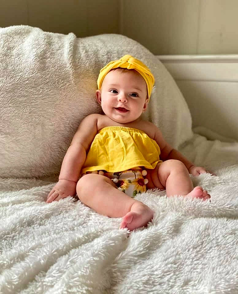 Annabeth joined the competition — help win amazing prizes! baby, baby_toddler_clothing, cheek, child, comfort, dress, eye, fun, happy, head, iris, leg, linens, person, sitting, skin, sleeve, smile, t_shirt, textile