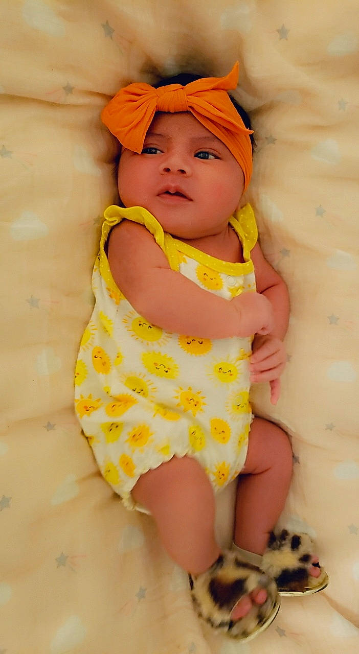 Sunny is registered to the contest to win money with this photo: baby, baby_toddler_clothing, child, headgear, headwear, person, skin, toddler, yellow