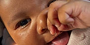 Grace is registered to the contest to win money with this photo: baby, child, close_up, cozy, cute, expression, face, fingers, hand, infant, newborn, person, pink_blanket, portrait, skin, smile, soft_light, tongue, warmth, young