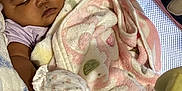 Grace joined the competition — help win amazing prizes! baby, sleeping, blanket, mittens, soft, floral_pattern, pink, cozy, infant, resting, face, head, person, child, closeup, indoors, comfort, peaceful, texture, fabric