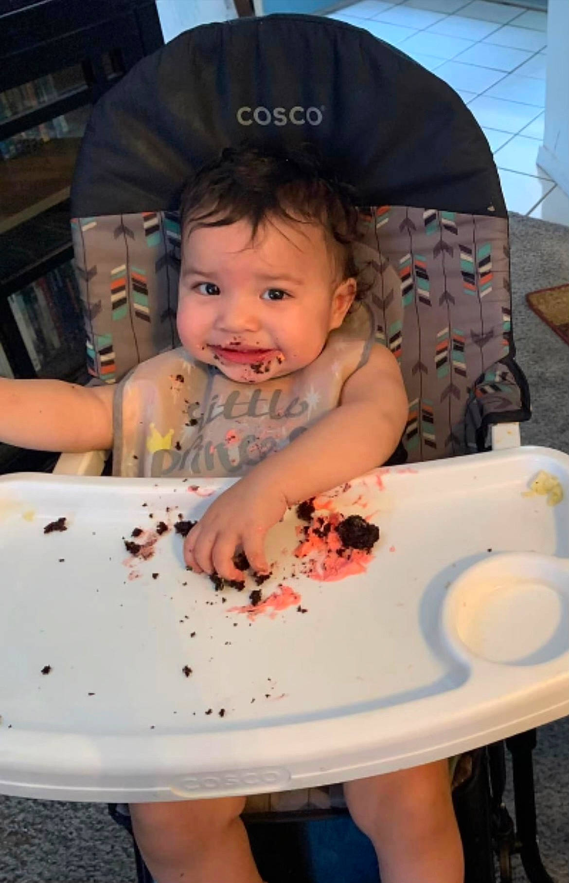 Liana is registered to the contest to win money with this photo: baby, baby_toddler_clothing, chair, cheek, child, dishware, event, food, fun, hairstyle, person, pink, plate, product, sitting, skin, smile, sweetness, table, tableware