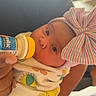 Thalia joined the competition — help win amazing prizes! baby, newborn, bottle, feeding, blanket, bow, hat, person, infant, wrapped, hand, indoors, window, light, cute, portrait, skin, clothing, care, hospital