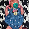 Thalia is registered to the contest to win money with this photo: baby, infant, pacifier, headband, bow, denim, minnie_mouse, clothing, socks, pattern, blanket, cow_print, lying_down, cute, small, newborn, person, indoors, fashion, accessory