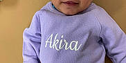 Akira joined the competition — help win amazing prizes! baby, infant, child, lavender, headwrap, clothing, smile, face, portrait, cute, laying_down, soft_surface, earrings, long_sleeve, small_hands, young_child, indoors, person, apparel, baby_girl