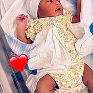 Harmony is registered to the contest to win money with this photo: newborn, baby, infant, hospital, blanket, onesie, hat, bassinet, swaddled, cute, sleepy, child, soft, white, pink, floral, resting, newborn_baby, tiny, peaceful