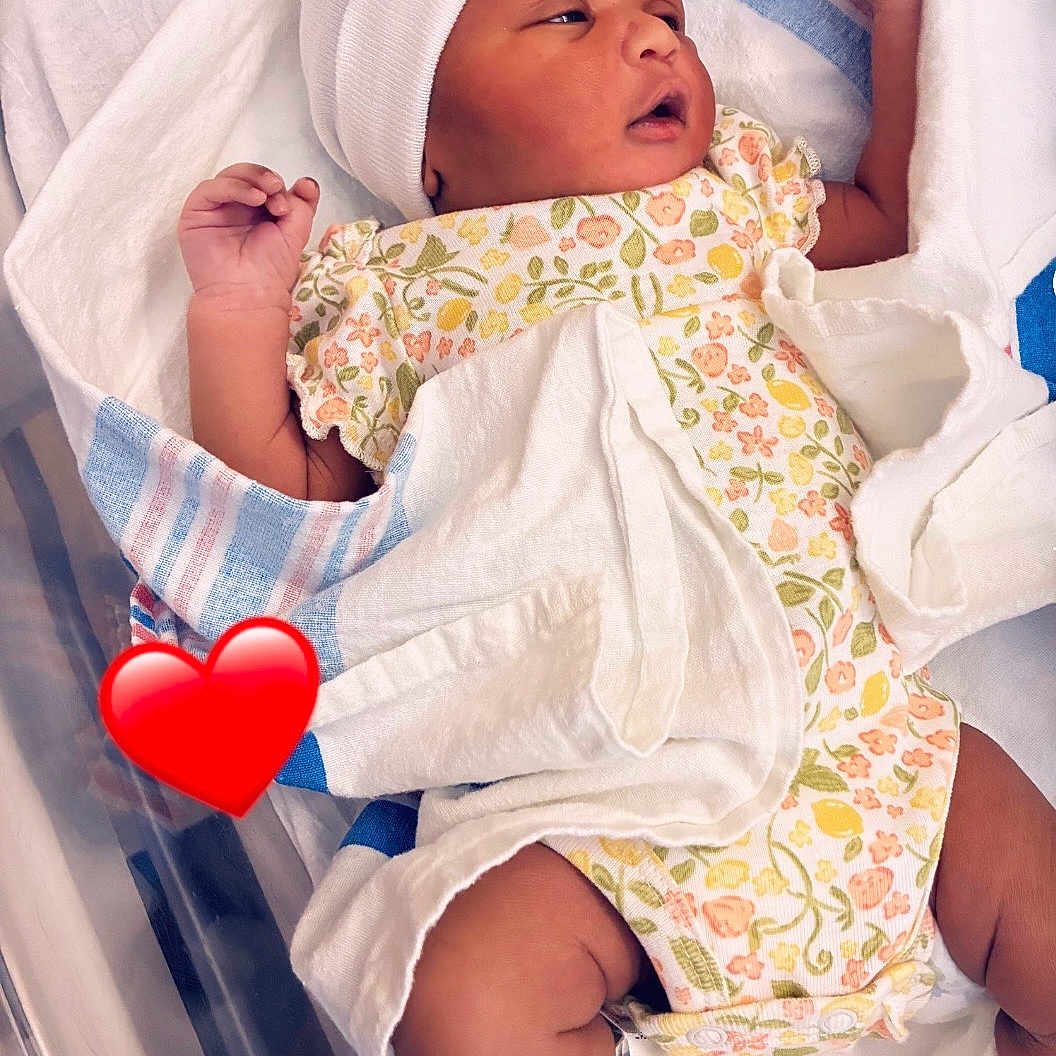 Harmony is registered to the contest to win money with this photo: newborn, baby, infant, hospital, blanket, onesie, hat, bassinet, swaddled, cute, sleepy, child, soft, white, pink, floral, resting, newborn_baby, tiny, peaceful