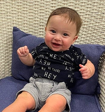 Preston is registered to the contest to win money with this photo: arm, baby_toddler_clothing, cheek, clothing, comfort, couch, face, finger, hand, happy, head, iris, lap, leg, mammal, person, product, skin, sleeve, smile