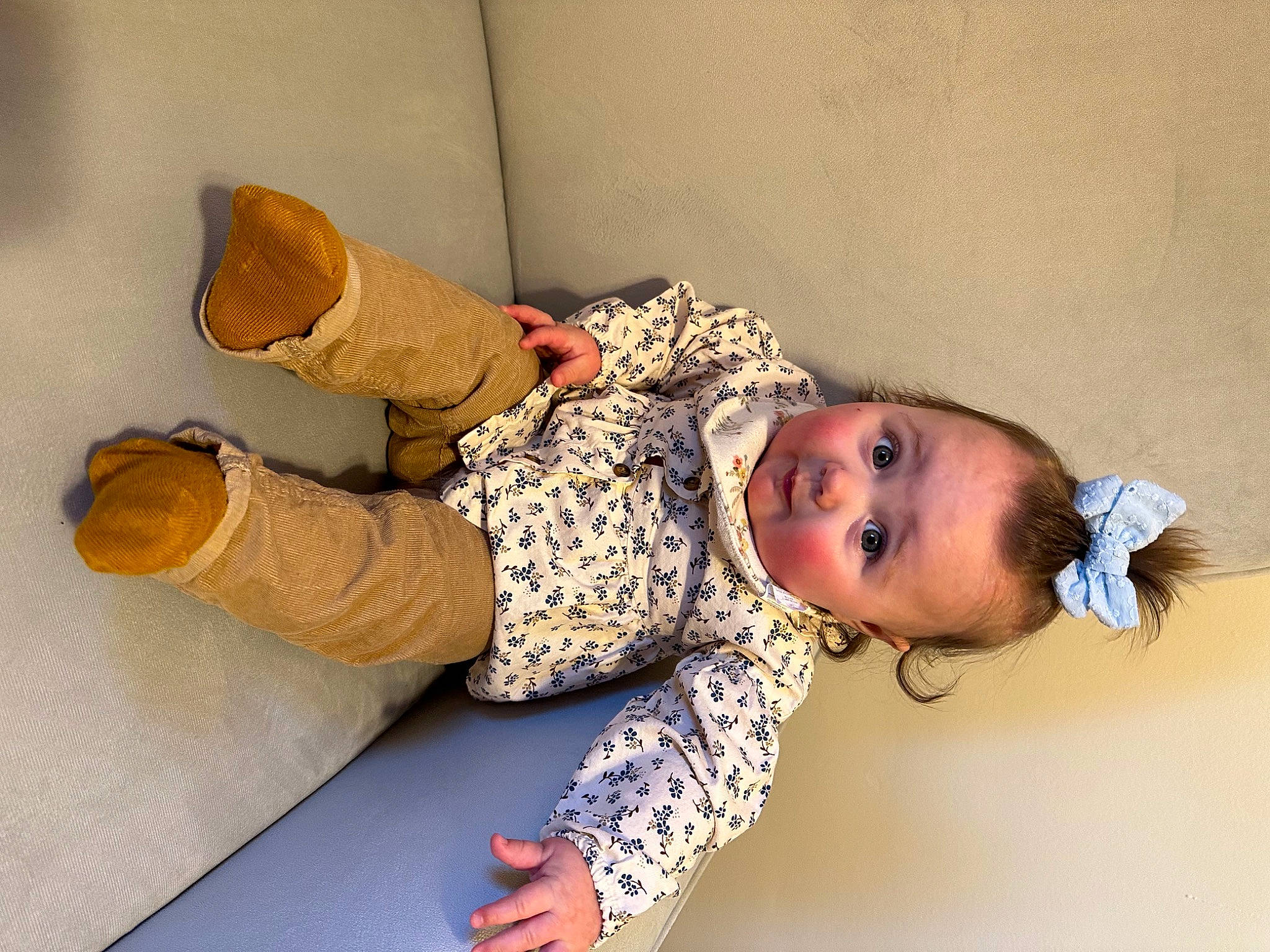 Elena is registered to the contest to win money with this photo: baby, baby_toddler_clothing, child, comfort, flooring, headgear, pattern, person, room, sitting, sleeve, sock, surprise, toddler, wood