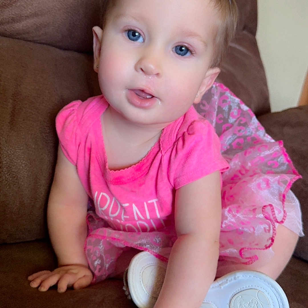 Madilynn joined the competition — help win amazing prizes! baby, bodypart, clothing, costume, couch, face, finger, footwear, furniture, hand, hat, head, homedecor, pants, partyhat, person, photography, portrait, shoe, t_shirt