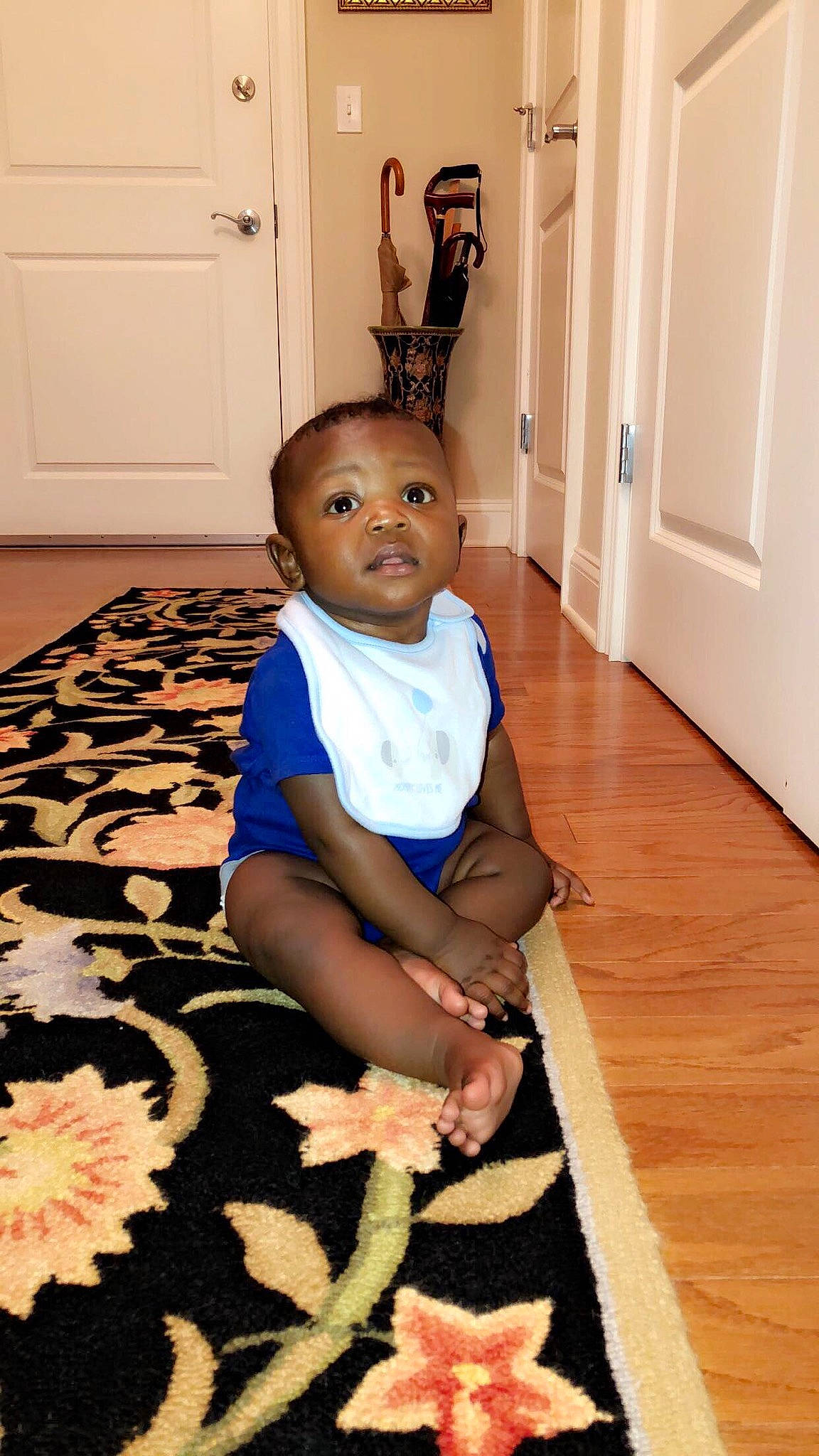 Juelz is registered to the contest to win money with this photo: baby, child, floor, flooring, hardwood, person, sitting, toddler