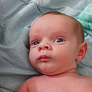 Emerson joined the competition — help win amazing prizes! baby, infant, face, eyes, skin, blanket, bed, lying_down, expression, curious, child, person, indoors, soft, comfort, newborn, head, shoulder, torso, young