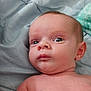 baby, infant, face, eyes, skin, blanket, bed, lying_down, expression, curious, child, person, indoors, soft, comfort, newborn, head, shoulder, torso, young