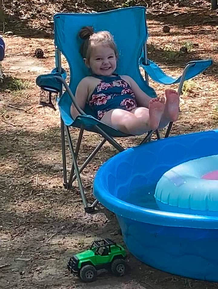 Kimberly is registered to the contest to win money with this photo: baby, baby_toddler_clothing, blue, chair, child, comfort, electric_blue, fun, grass, green, joy, leisure, outdoor_furniture, person, plant, product, recreation, sitting, smile, tire