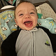 Myles joined the competition — help win amazing prizes! baby, smiling, teeth, face, infant, blanket, pattern, sheep, moon, clothing, onesie, happy, portrait, indoor, soft, cute, child, expression, sleeping_area, photograph
