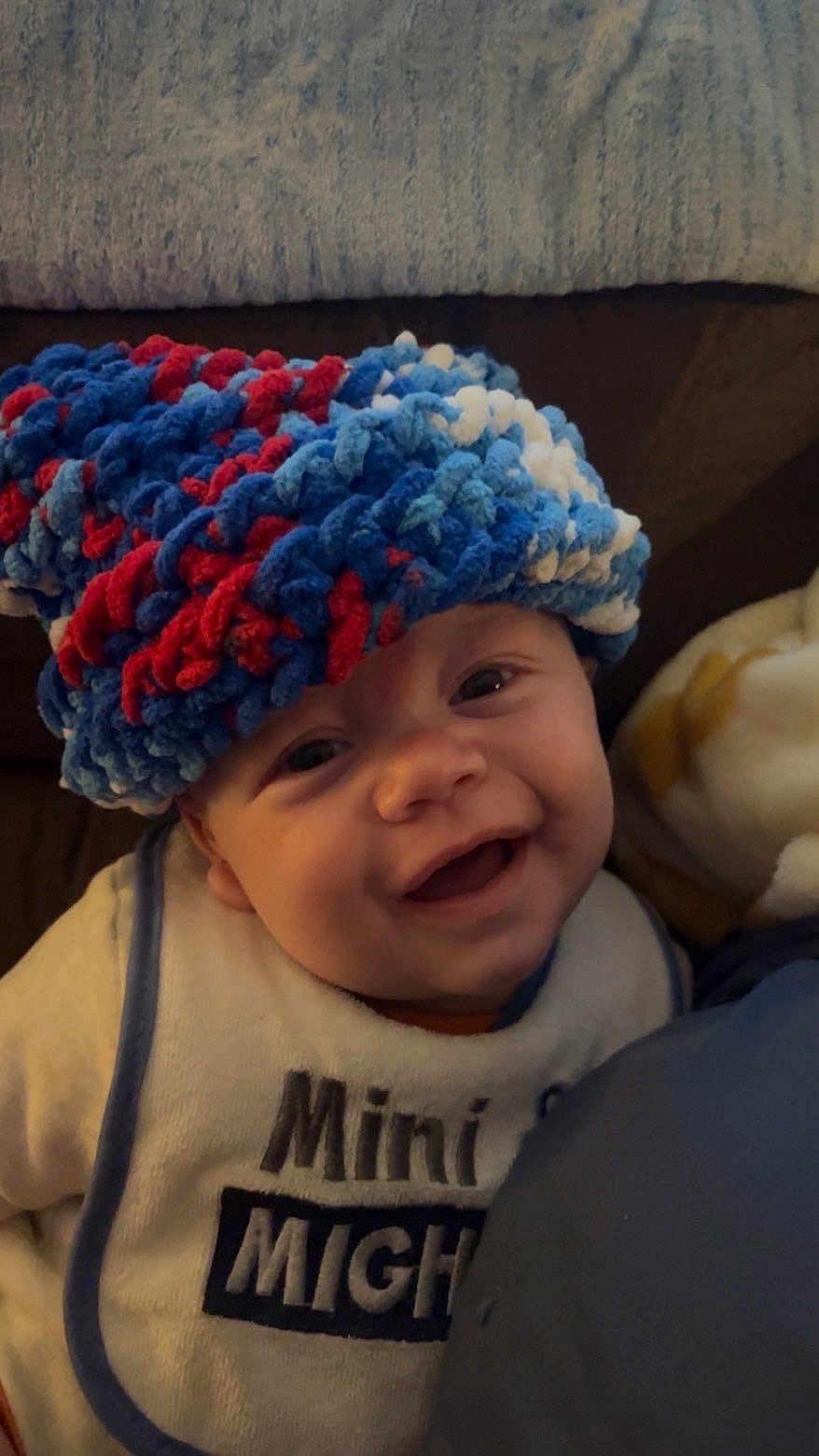 Stetson joined the competition — help win amazing prizes! baby, smiling, hat, knitted, colorful, bib, indoor, face, cute, child, young, happy, cozy, portrait, person, apparel, text, fabric, headwear, infant