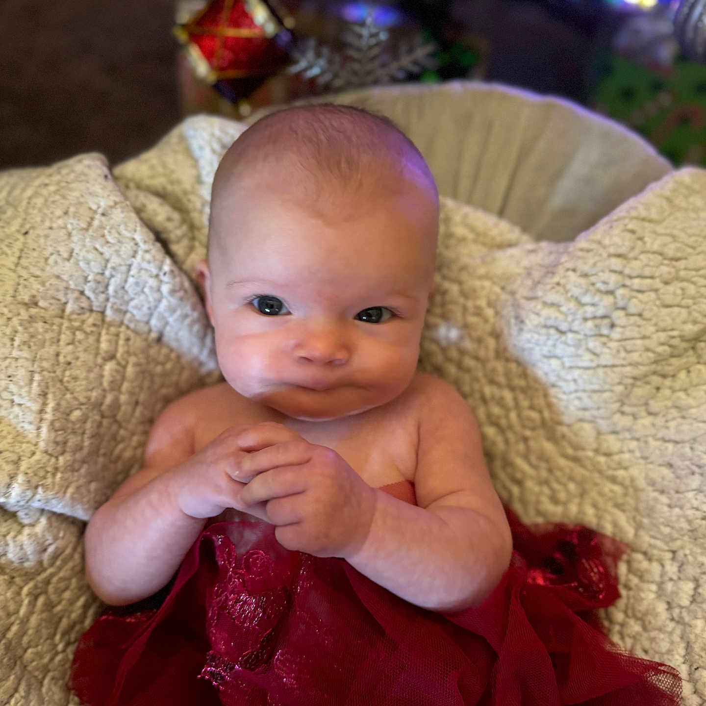 Athena is registered to the contest to win money with this photo: accessories, baby, bodypart, clothing, couch, dress, face, finger, furniture, hand, happy, head, homedecor, linen, newborn, person, photography, portrait, sitting, smile