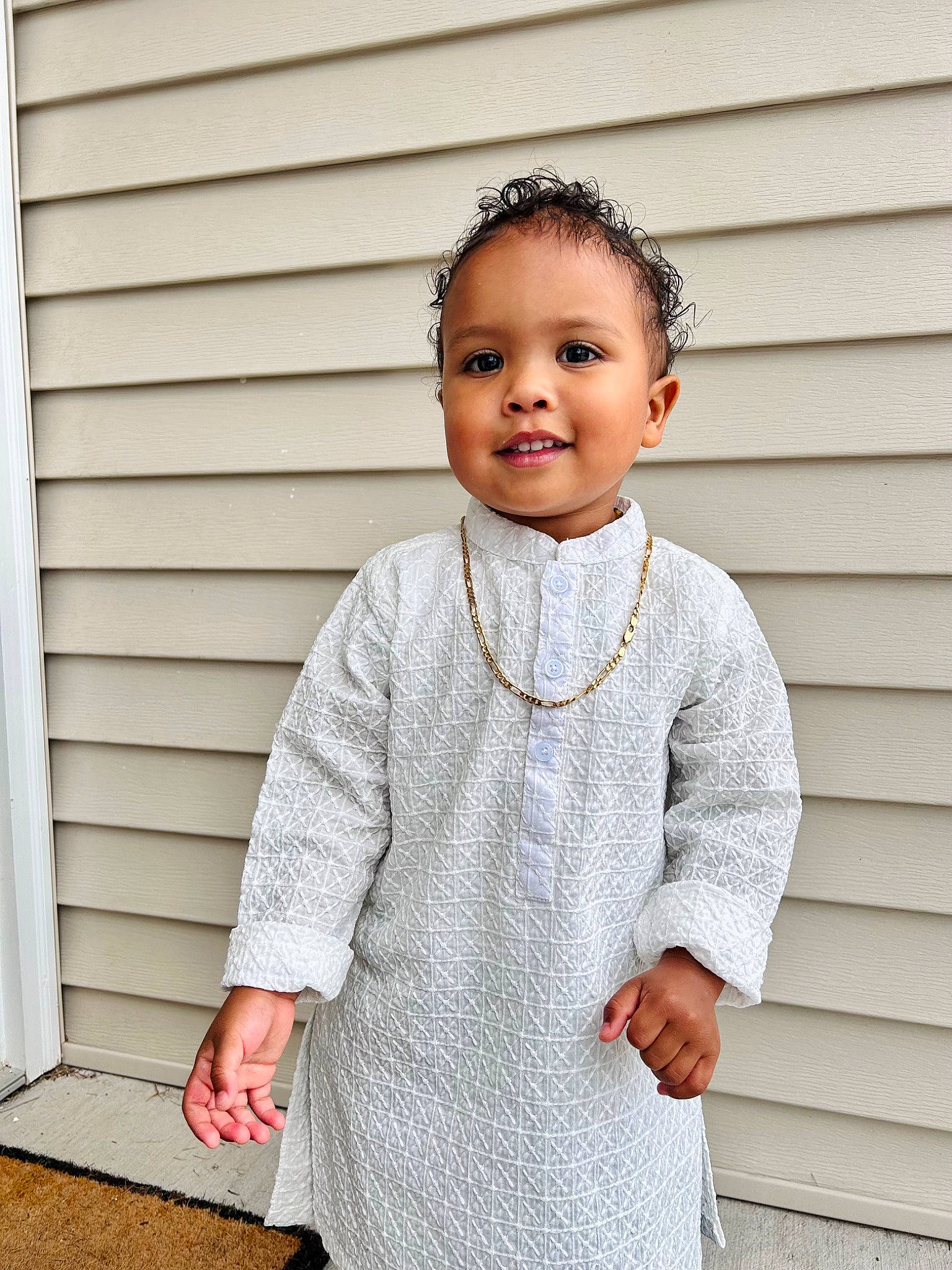 Emi is registered to the contest to win money with this photo: baby_toddler_clothing, blazer, child, collar, dress_shirt, elbow, gesture, grey, happy, jewellery, joy, neck, necklace, pattern, person, rectangle, shoulder, sleeve, smile, t_shirt