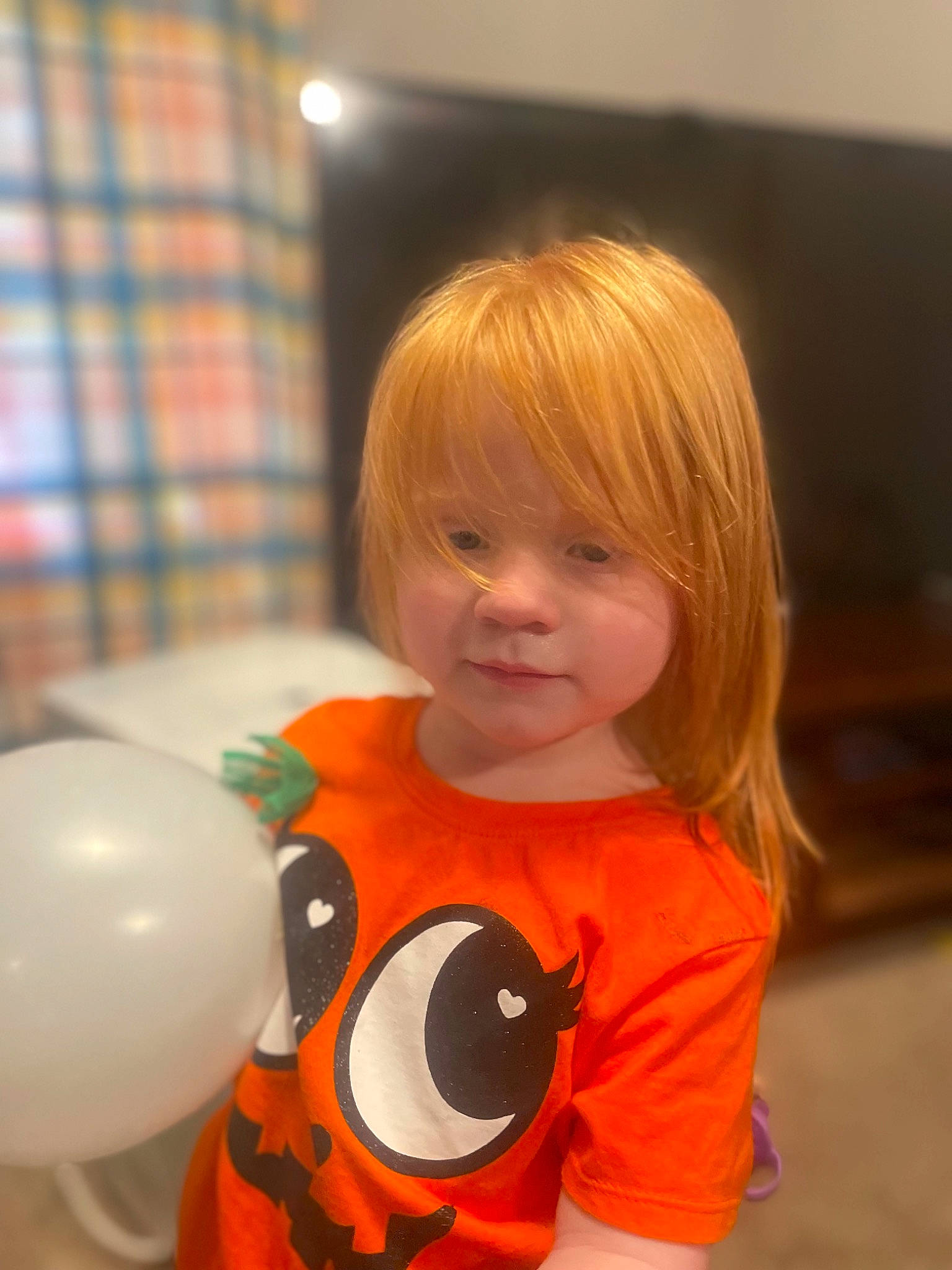 Annetta is registered to the contest to win money with this photo: baby, baby_toddler_clothing, balloon, bangs, child, circle, event, fun, happy, orange, party, party_supply, pattern, person, plaid, play, room, sleeve, t_shirt, tartan