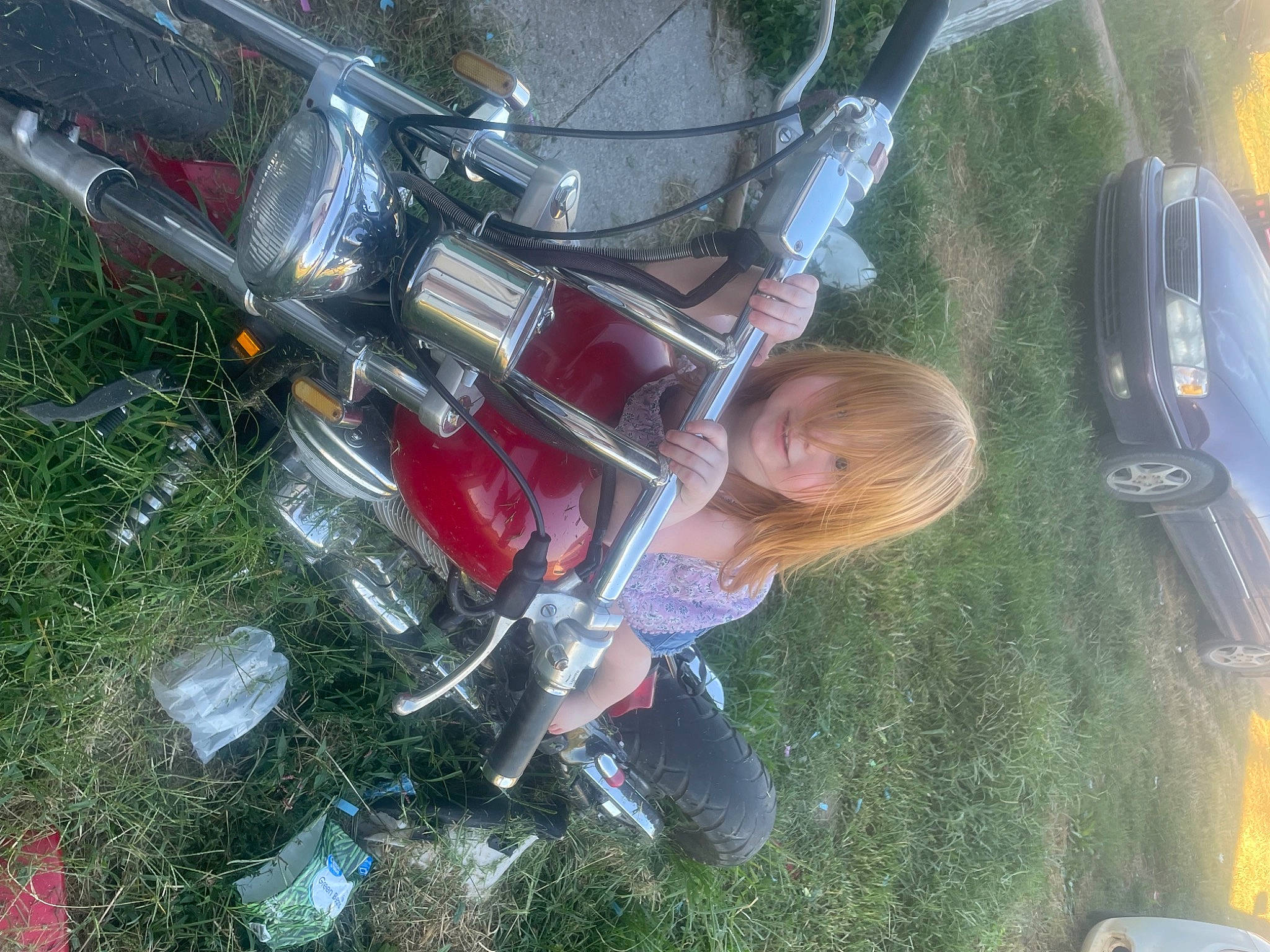 Annetta is registered to the contest to win money with this photo: automotive_design, automotive_exterior, automotive_lighting, automotive_tail_brake_light, automotive_tire, automotive_wheel_system, bumper, car, fender, fuel_tank, grass, headlamp, hood, motor_vehicle, motorcycle, person, rim, tire, vehicle, vehicle_door