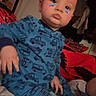 Timothy is registered to the contest to win money with this photo: toddler, child, portrait, sitting, bedroom, bed, pajamas, blue_clothing, vehicle_pattern, cars, trucks, butterfly_stickers, face, eyes, indoor, blanket, bedding, clothing, serious_expression, photography