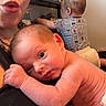baby, infant, toddler, child, adult, family, portrait, selfie, sitting, lying_down, wide_eyes, glasses, nose_ring, short_hair, diaper, clothing, indoor, home, shelf, funny_face