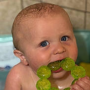 Steven joined the competition — help win amazing prizes! baby, child, teething_ring, blue_eyes, close_up, infant, skin, hand, mouth, toy, bath, water_drops, cute, expression, indoor, portrait, head, chewing, holding, playful