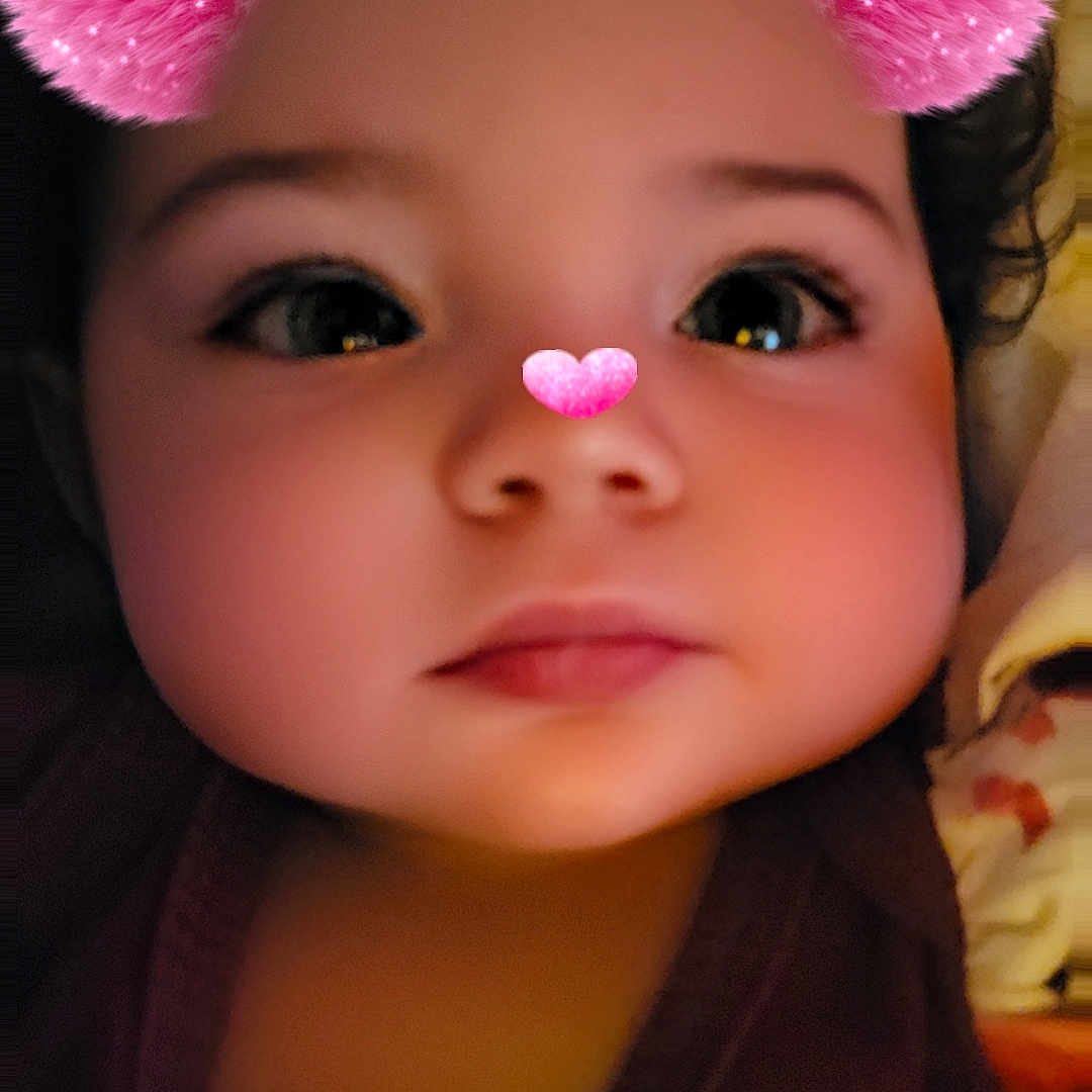 Kynlynn joined the competition — help win amazing prizes! adorable, baby, blanket, cheeks, child, closeup, clothing, curly_hair, cute, eyes, face, filter, heart_nose, indoors, lips, pink_ears, portrait, snapchat_filter, soft_skin, toddler