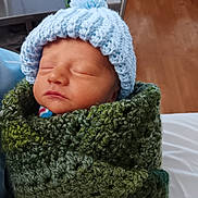 Jaxson is registered to the contest to win money with this photo: newborn, baby, sleeping, hat, knitted, blanket, green, blue, cozy, infant, portrait, child, indoor, warm, soft, face, headwear, wrapped, peaceful, cute