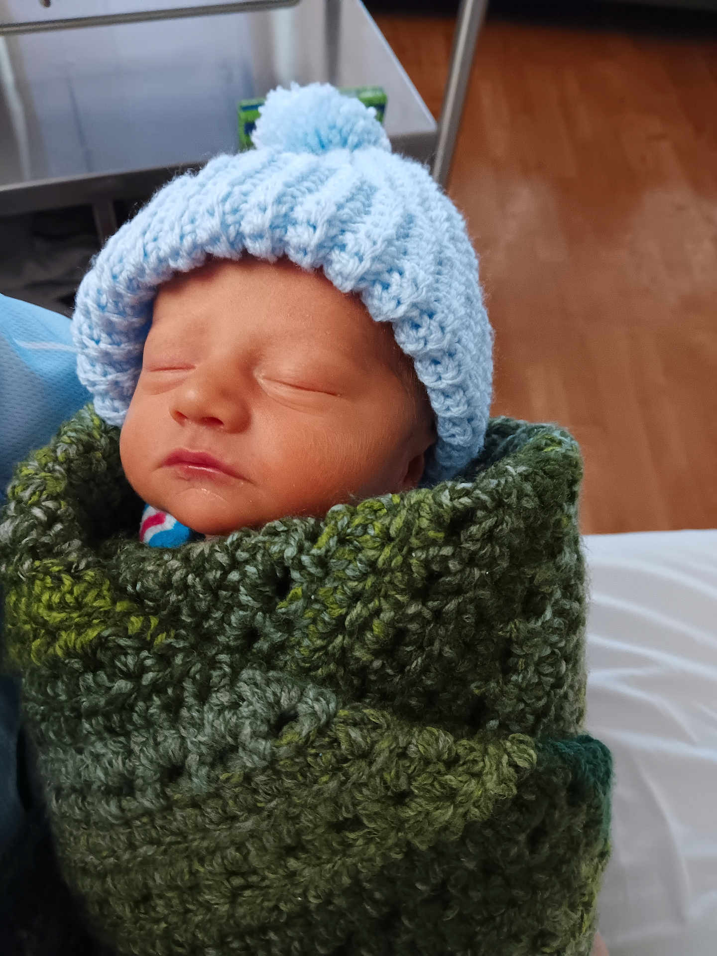 Jaxson is registered to the contest to win money with this photo: newborn, baby, sleeping, hat, knitted, blanket, green, blue, cozy, infant, portrait, child, indoor, warm, soft, face, headwear, wrapped, peaceful, cute