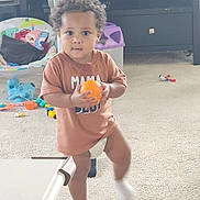 Zacc joined the competition — help win amazing prizes! toddler, child, indoor, carpet, toy, orange_ball, brown_shirt, diaper, white_sock, furniture, living_room, curly_hair, person, playtime, cute, standing, carpeted_floor, plastic_toy, baby_chair, candid