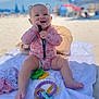 Kovelynn is registered to the contest to win money with this photo: baby, infant, beach, towel, toys, sunny, smiling, happy, child, outdoor, sand, umbrella, play, colorful, cute, pigtails, summer, relaxation, vacation, clothing