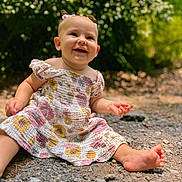 Kovelynn joined the competition — help win amazing prizes! baby, child, smiling, outdoor, dress, floral_pattern, grass, greenery, happy, sitting, foot, pigtails, pink_bow, cute, nature, sunlight, portrait, garden, ground, face
