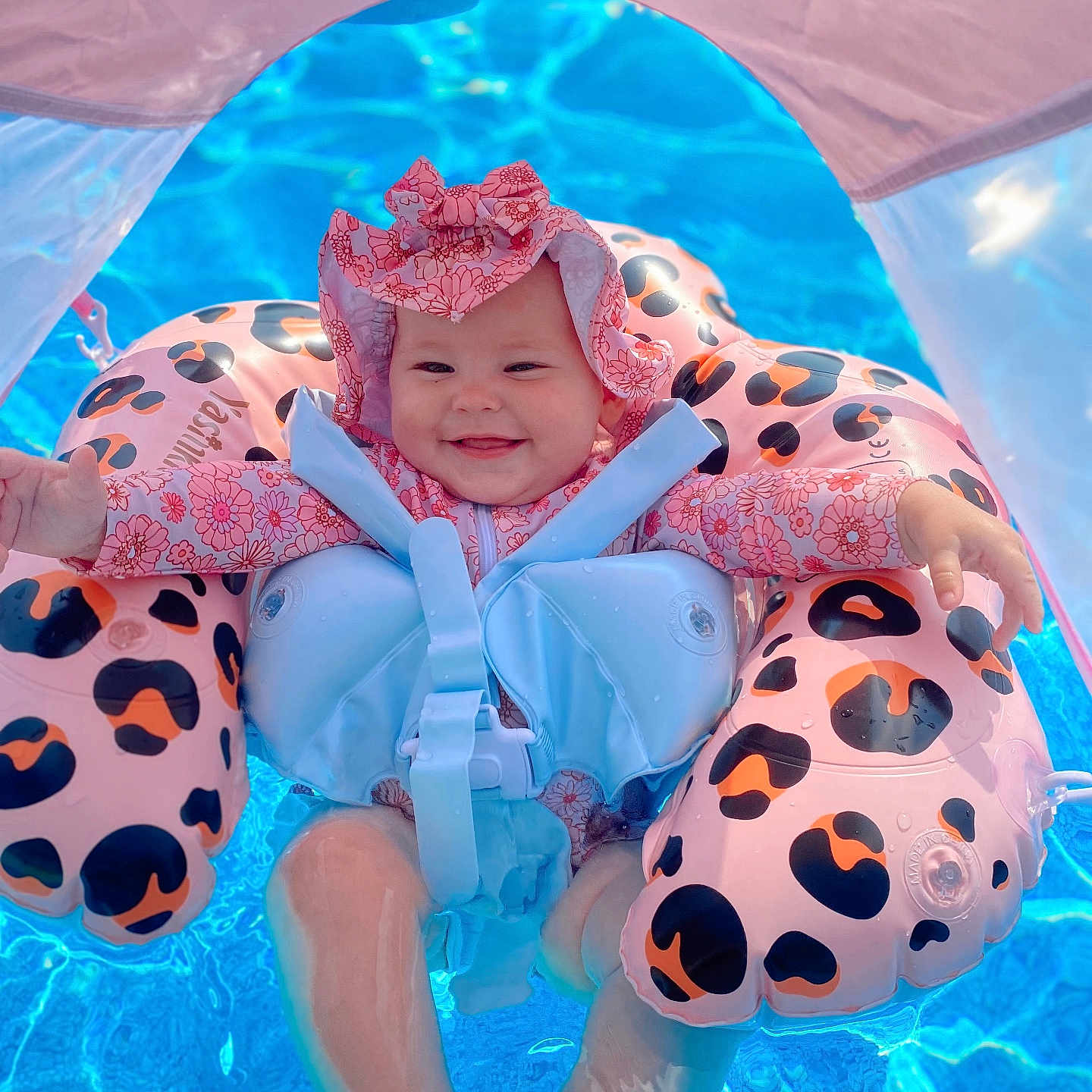 Kovelynn is registered to the contest to win money with this photo: baby, blue_water, child, cute, floatie, floating, fun, infant, joy, leopard_print, outdoor, relaxation, safety, smile, summer, sunhat, sunshade, swimming_pool, swimsuit, water