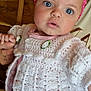 River-Rose is registered to the contest to win money with this photo: baby, child, headband, flower, pink, white, crocheted_sweater, clothing, face, eyes, hand, person, indoor, wooden_wall, curious, cute, holding_hand, sitting, apparel, portrait