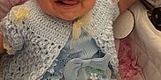 River-Rose is registered to the contest to win money with this photo: baby, child, blue_bow, headband, crochet_sweater, floral_dress, stroller, pink_blanket, smiling, tongue_out, cute, infant, happy, seated, soft_fabric, closeup, indoors, adorable, person, portrait