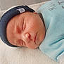 newborn, baby, sleeping, hat, blue_clothing, blanket, face, skin, infant, cozy, resting, closeup, cute, peaceful, child, portrait, indoors, person, soft, newborn_skin