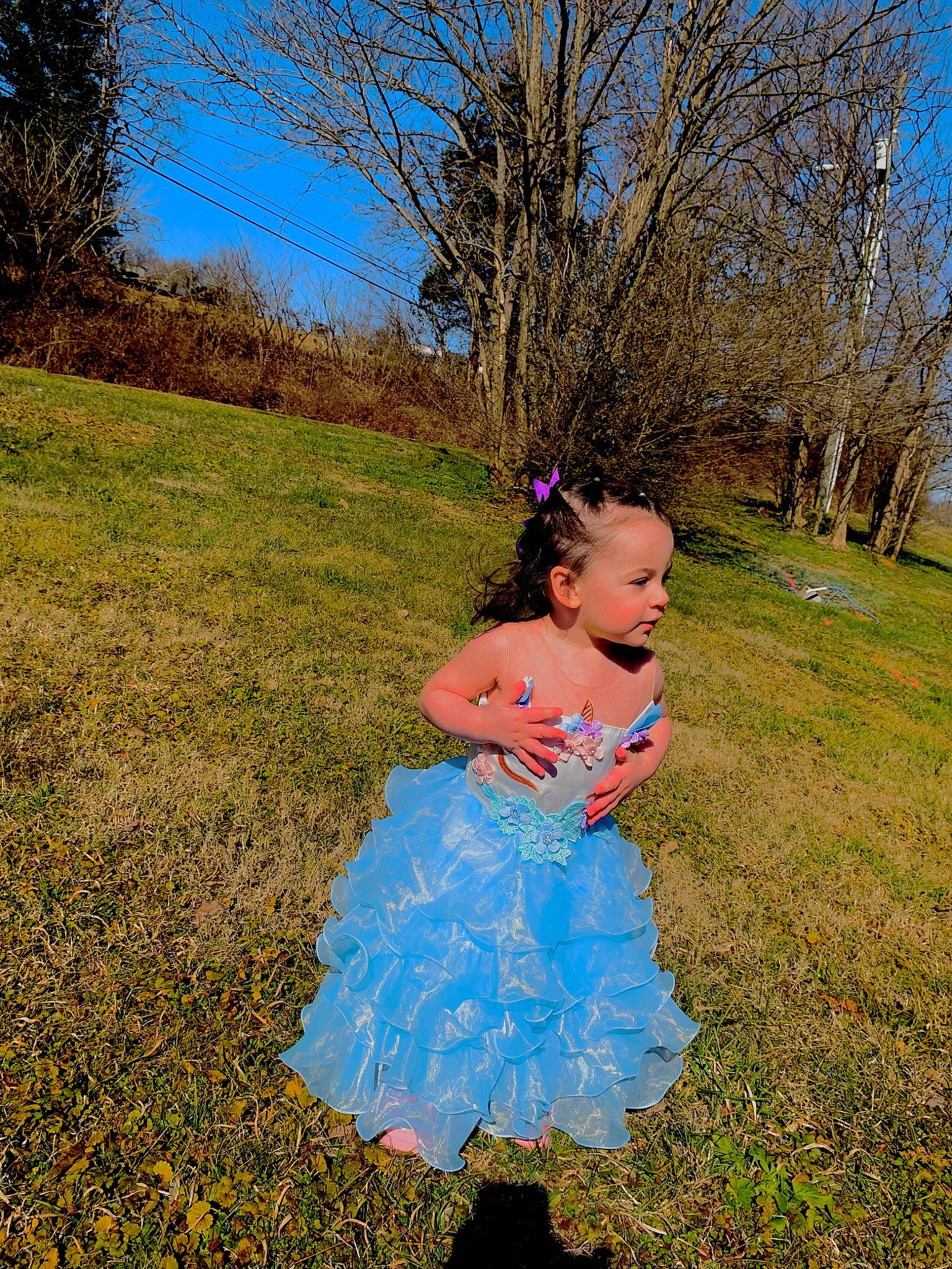 Neveah is registered to the contest to win money with this photo: baby_toddler_clothing, dress, electric_blue, grass, grass_family, grassland, happy, landscape, leisure, meadow, people_in_nature, person, plain, plant, prairie, recreation, rural_area, sky, toddler, tree