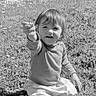 baby, black_and_white, casual_clothing, child, cute, daylight, field, flower, garden, grass, happy, innocence, nature, outdoor, playful, portrait, sitting, smiling, toddler, young_child